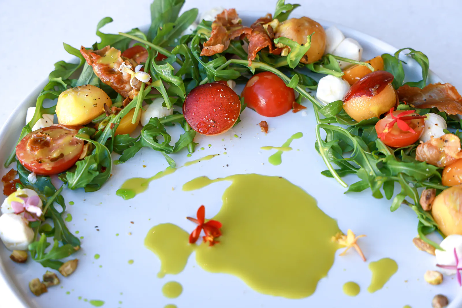 A plated salad with heirloom tomatoes and greens