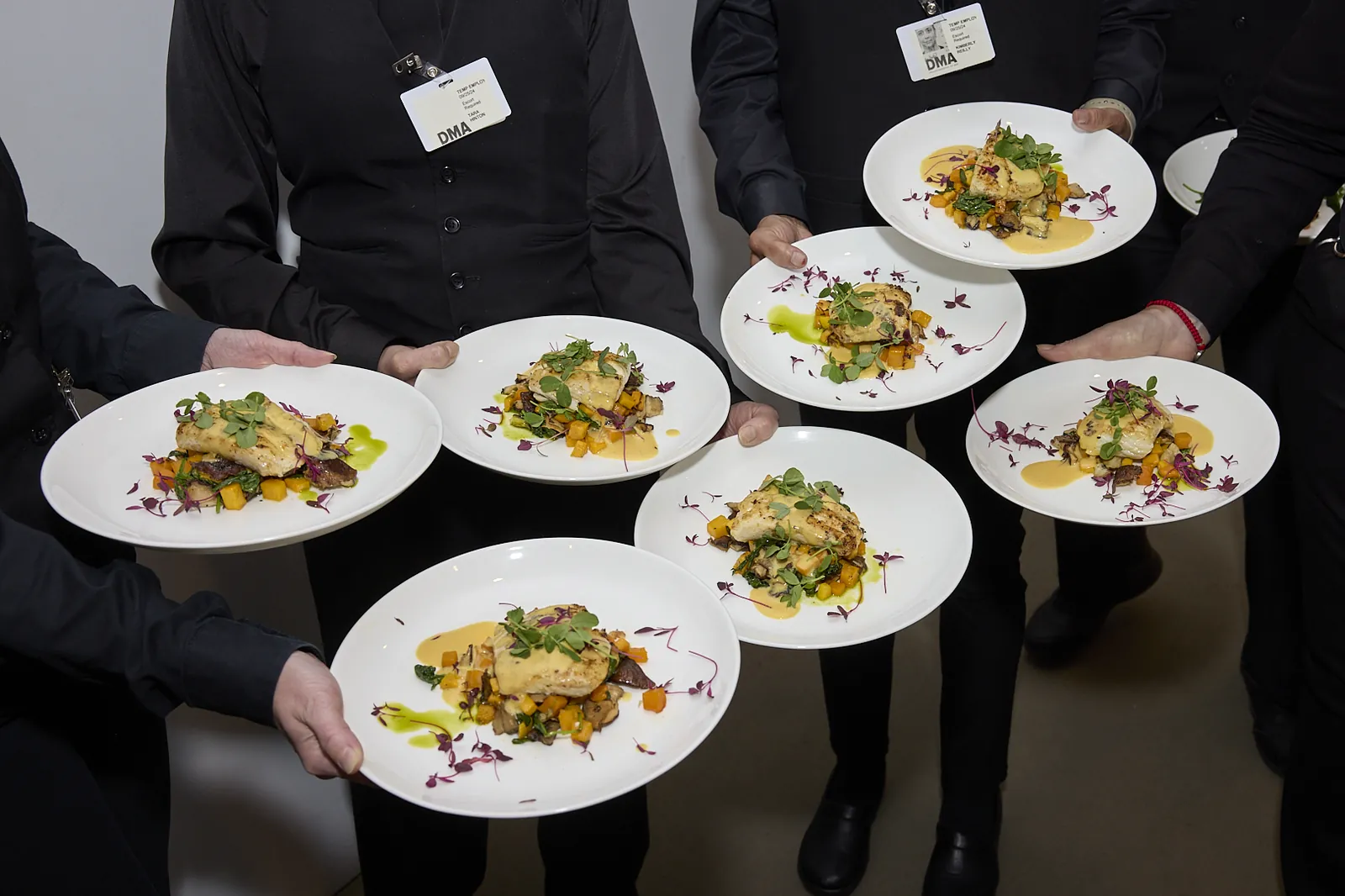 Servers carrying plated courses to the floor