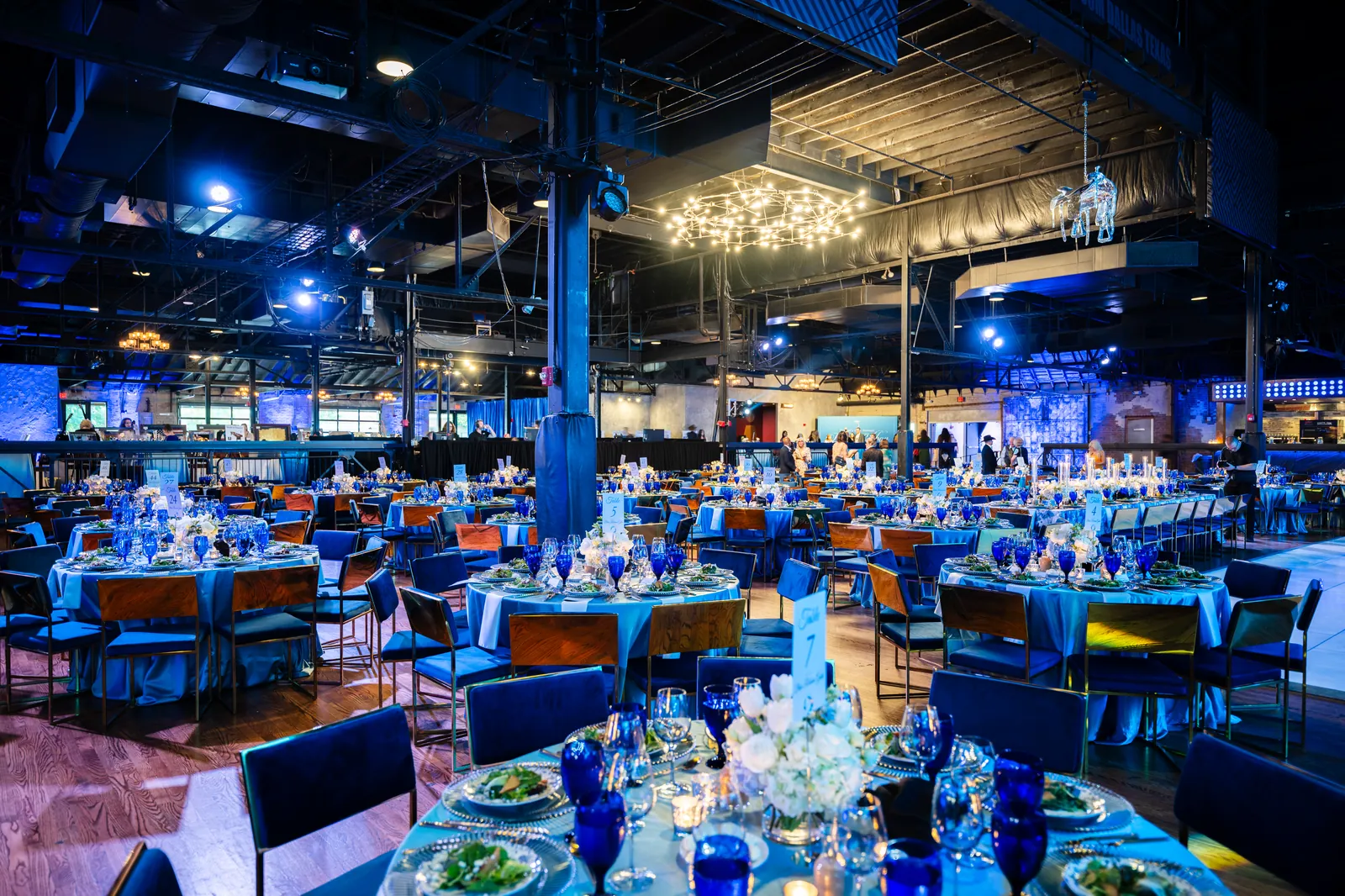 A large event room under blue uplighting