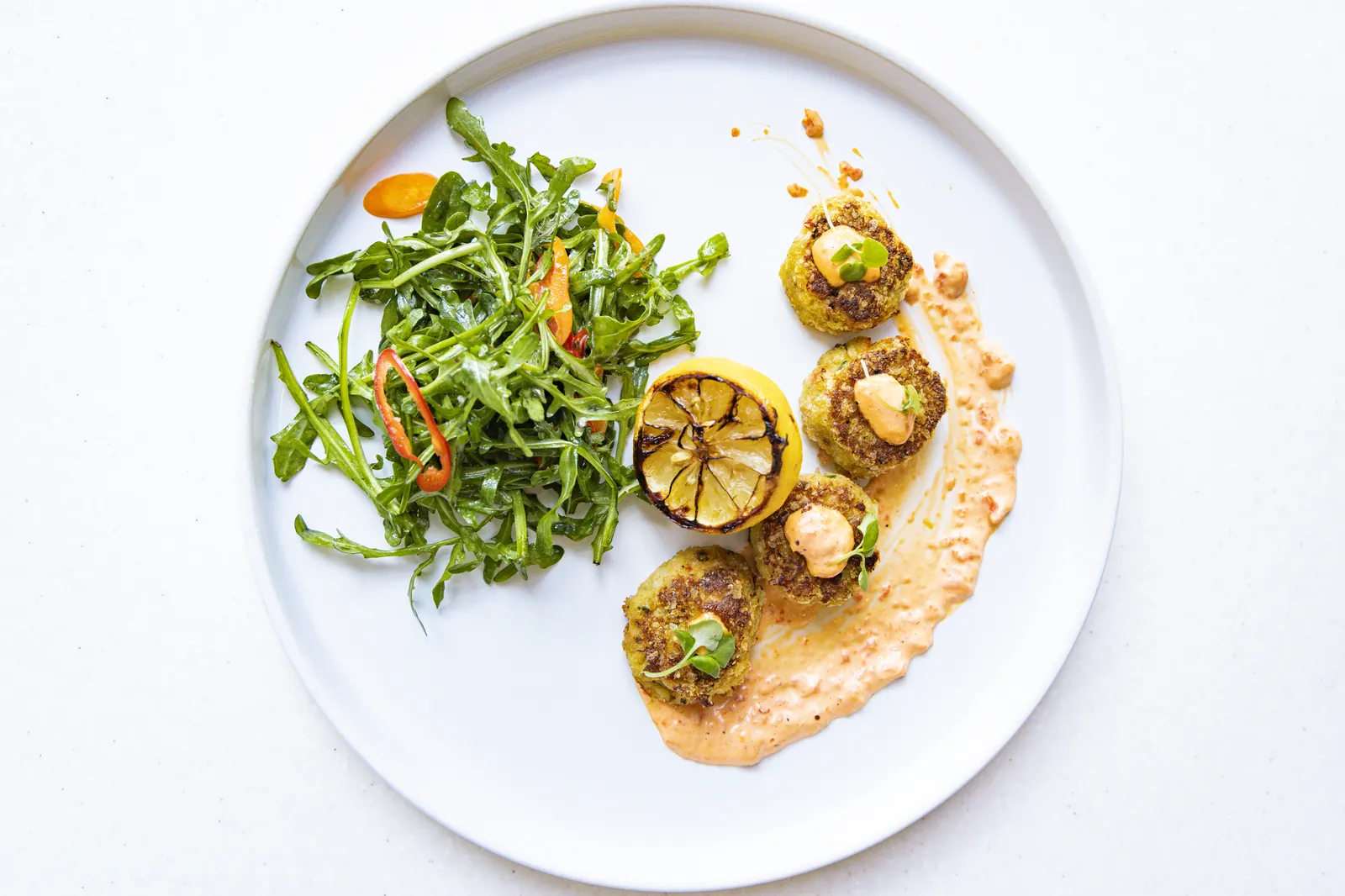A plated salad with grilled lemon