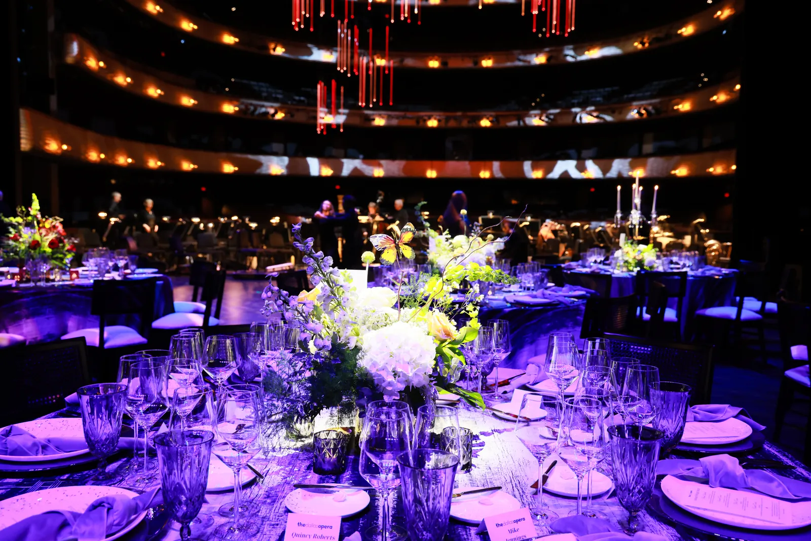 A purple-lit gala dinner in a theatre